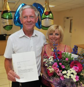 Norman with wife Alison and the 1976 letter confirming his appointment as a process worker. 