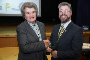 Beryl Clay receives a leaving gift from committee chairman Jason Martindale.