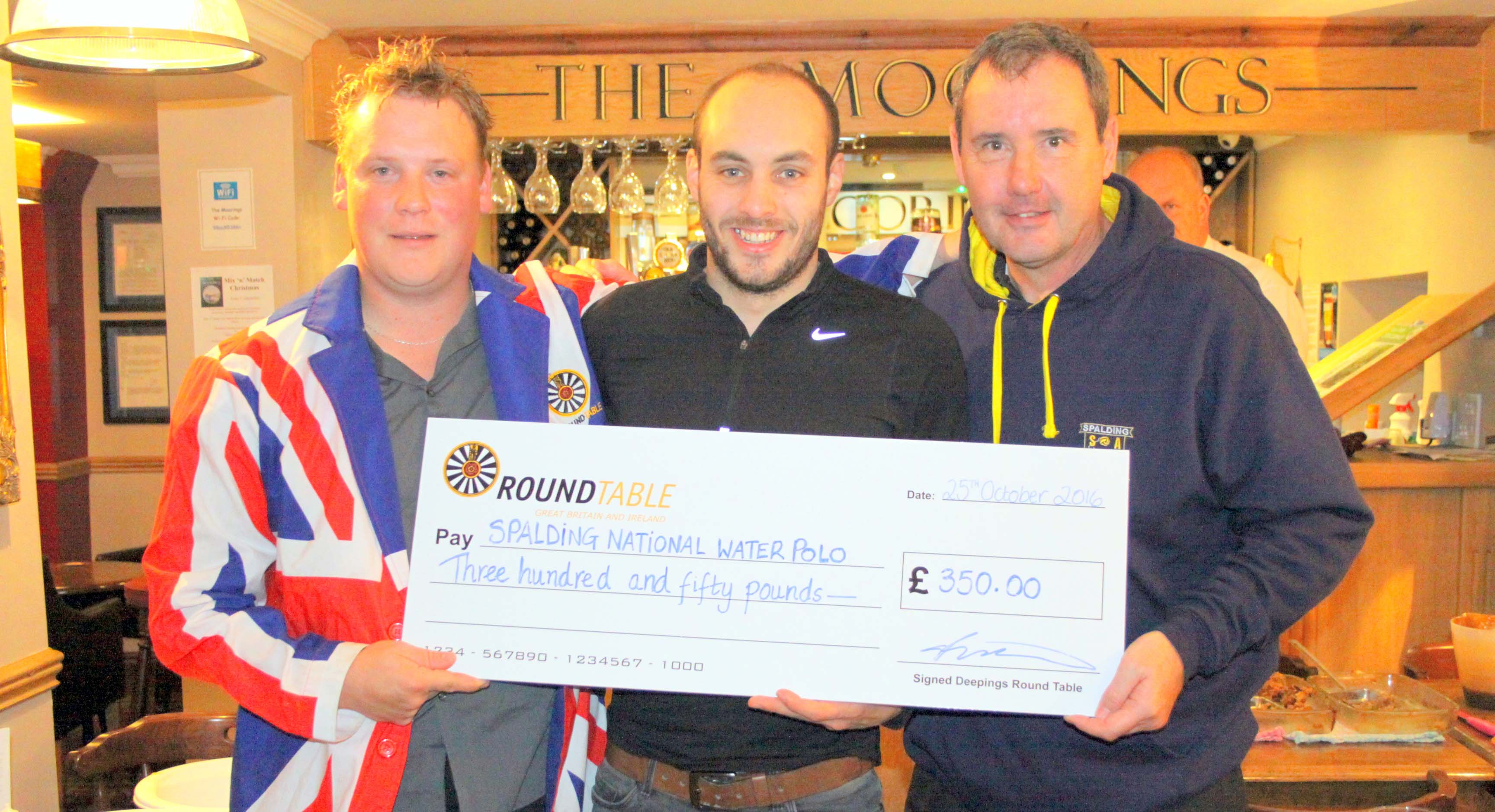 GENEROUS GIFT: Spalding captain Ben Masters (centre) and head coach Dave Lord (right) receive £350.