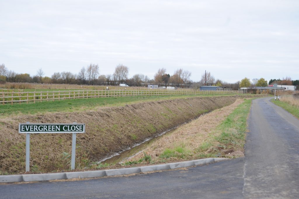 The new development off Drain Bank North in Spalding, which abuts (right) a currently unauthorised travellers’ site.